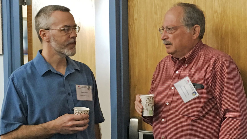Professor Steven R. J. Brueck in discussion with an AFRL guest